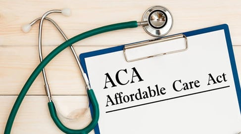 ACA on a clipboard next to a stethoscope