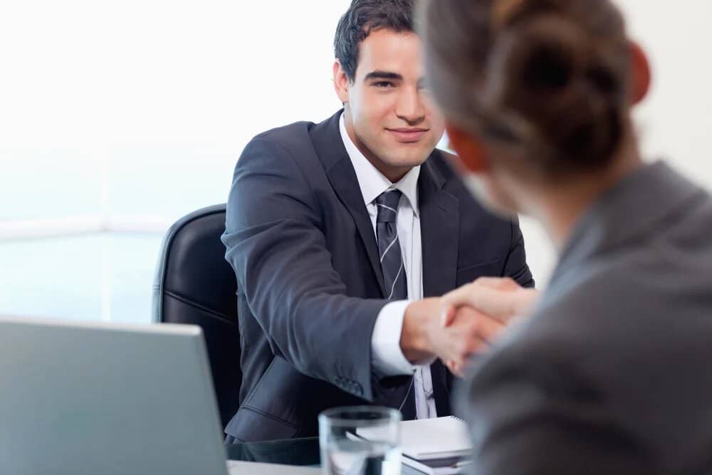 businessman shaking business womans hand 