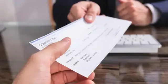 paycheck being handed to a person